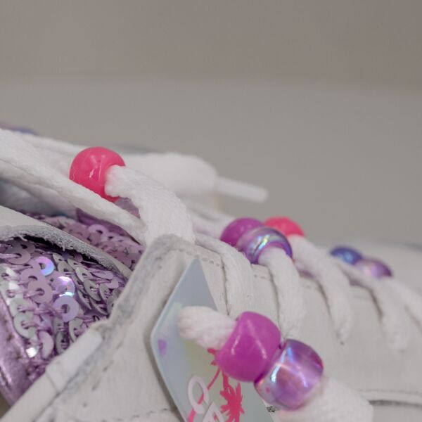 Crime London sk8 charms, in vera pelle colore bianco con dettagli laminato argento, paillettes lilla e lacci con perline.